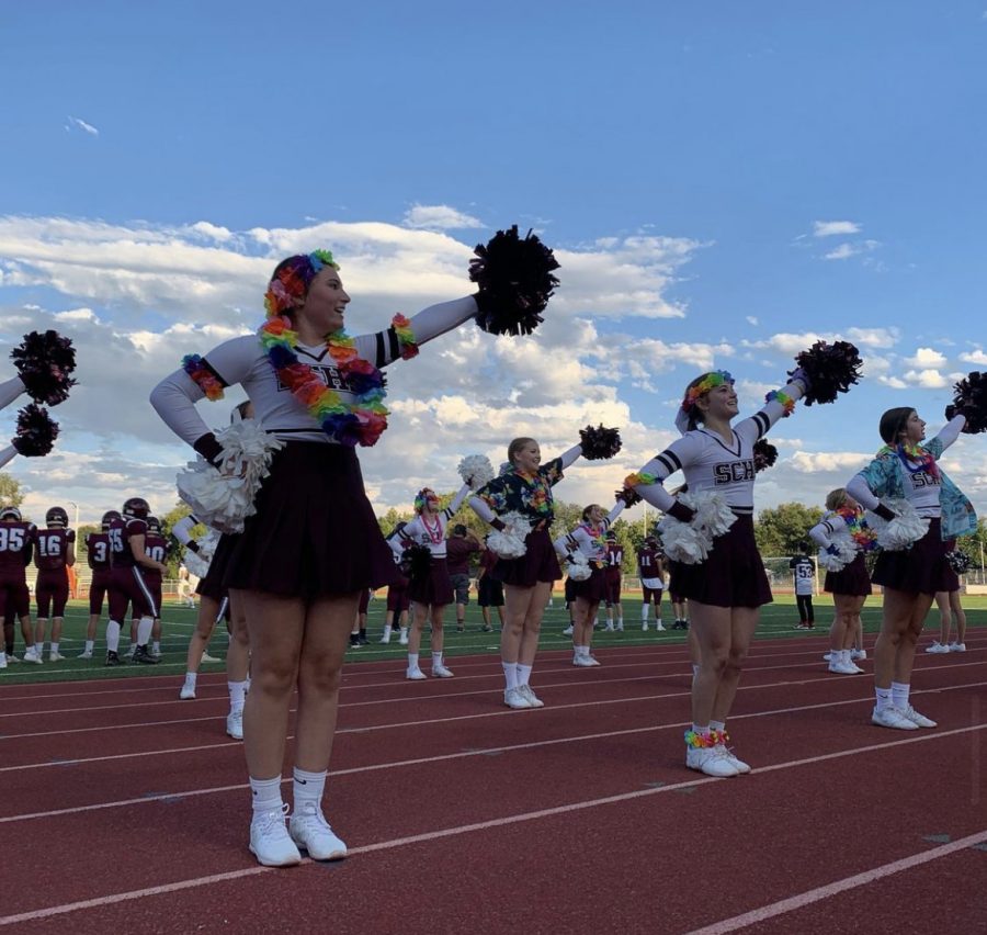 Varsity captains, Olivia Enright, Bridget Hauger, and Lanie Kilpatrick, lead their team in their “Hey Raptors Go SC” cheer. This was taken at one of the first home football games at Longmont High School of the season.