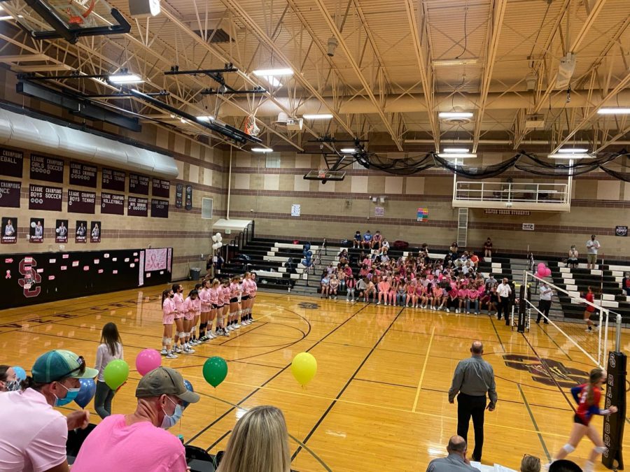 The Silver Creeks volleyball team lines up during roster announcements while students fill the student section for the Raptors annual dig pink match. In honor of it being October and breast cancer awareness month, the Silver Creek volleyball team repped their pink jerseys while the fans participated in a pink out. Coming off a 4-0 winning streak, the raptors looked to continue the streak taking on Centarus on Thursday October, 8th. With the amazing support from fans, the raptors took the match, sweeping the Warriors in three sets.