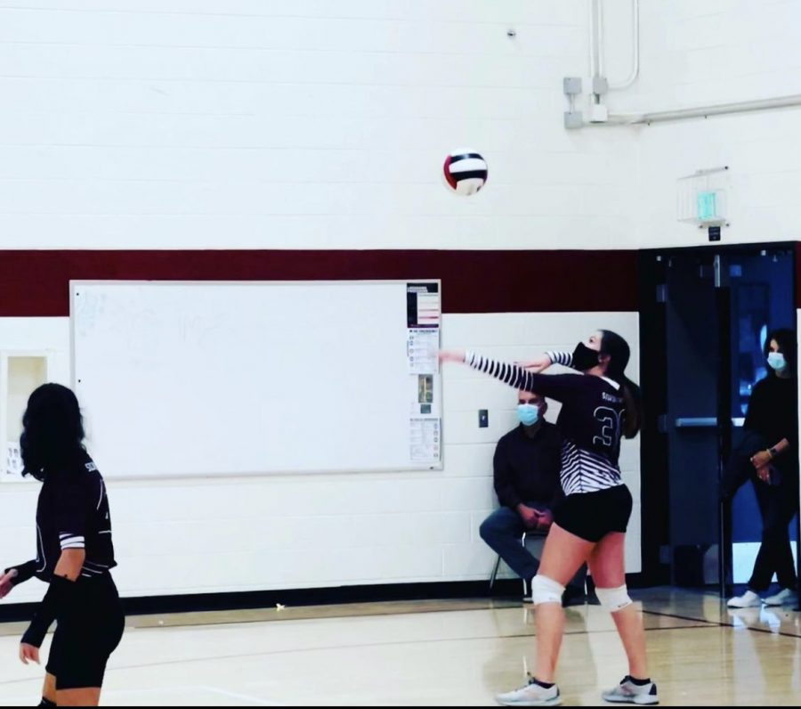 Swinging+her+hardest+at+the+ball%2C+Freshman+volleyball+player+Anna+Scalf+serves+the+ball+during+a+game+at+Skyline+High+School.+Anna+Scalf+says%2C+%E2%80%9C+Serving+the+ball+is+a+weird+feeling%2C+everyone+%5Bis%5D+watching+you+either+succeed+or+fail.%E2%80%9D+Serving+the+ball+is+one+of+the+main+parts+of+volleyball%2C+the+way+to+start+a+game.+Despite+that+weird+feeling%2C+she+says%2C+%E2%80%9CI+am+more+worried+about+the+ball+going+over%2C+than+who+is+actually+watching%E2%80%9D.