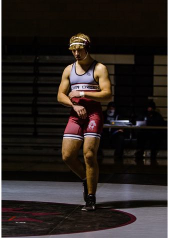 Walking up to the mat is senior Pepi Dostal who wretsled in the 220 weight class last Thursday, December 2nd in the duel against Niwot High School.