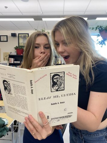 Bridget Curry and Ruby Walker enjoying the book Bless Me Ultima in Language Arts class.
