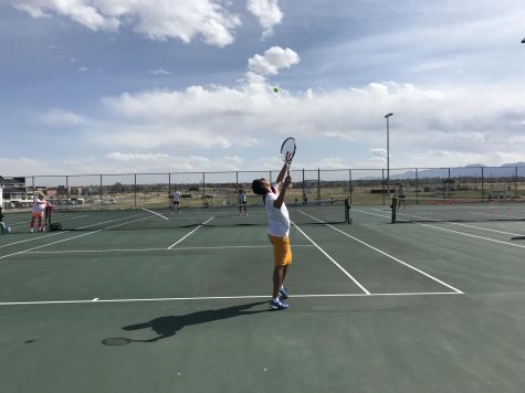 Silver Creek Tennis Coach Justin Thompson serves up a point while Coach Sara Whiteley is frozen on the side of the court. The goal of the tournament was to “[have] a fun day of tennis, be outside and have different people on the court,” says Whiteley.