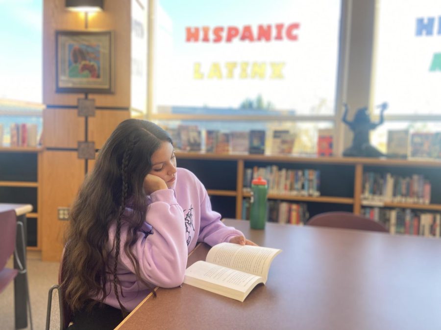 Sophomore Leelianna Gurrola reads one of the many books the library is offering to students to read about Latinx Heritage Month. She is reading this book so she can learn more information about the culture. Gurrola says, “The reason Im reading these books is to understand an idea of what my ancestors lived like in Mexico, I’m part of the Latinx community and want to learn more about my culture.”