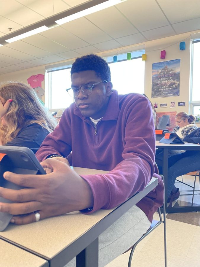 Looking at his iPad, Senior Malik Roth starts editing his college essay. Silver Creek High School students are participating in Colorados Free College Application Day.