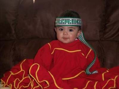 Diamari Flores, age one is seen wearing a traditional dress worn by the women of the Rarámuri Tribe of Chihuahua, Mexico. This dress is worn during celebrations and in memorial of their Indigenous Ancestors.