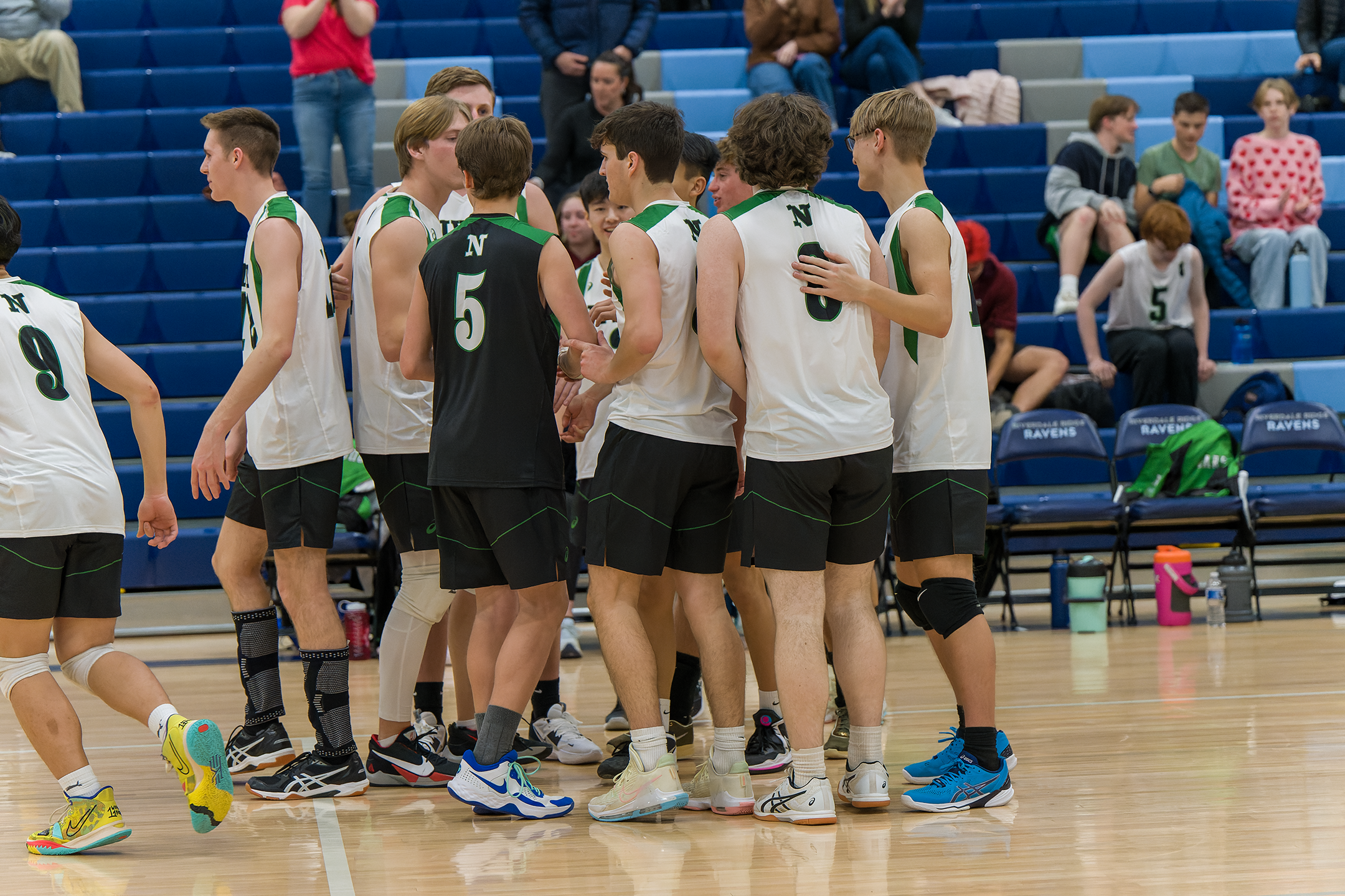 This photo is from the Boys’ Volleyball game from their very first duel game. The Boys are huddling together after a good game last weeks game