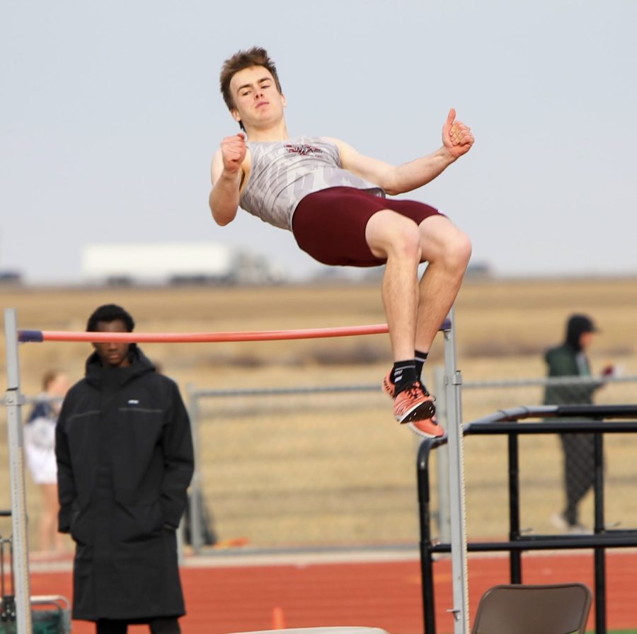 Jumping over the height of 5 feet 10 inches, Senior sprinter and Jumper Birch Neeld goes over the bar. During the First track meet of the season held on March 10th, Neeld finished 2nd place overall.