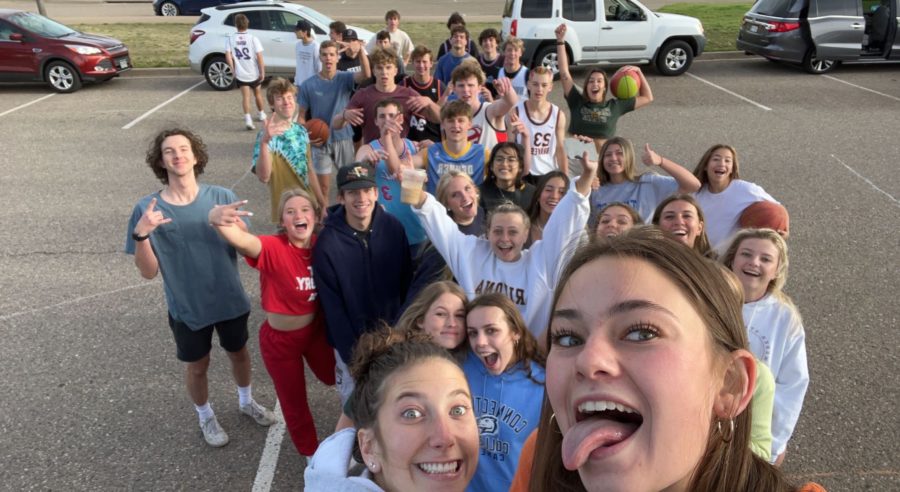In+the+early+summers+of+2022%2C+seniors+filled+into+the+parking+lot+for+their+senior+prank+and+pose+for+a+quick+photo.+They+placed+a+basketball+hoop+in+the+middle+of+the+parking+lot+and+played+a+big+game+before+school.