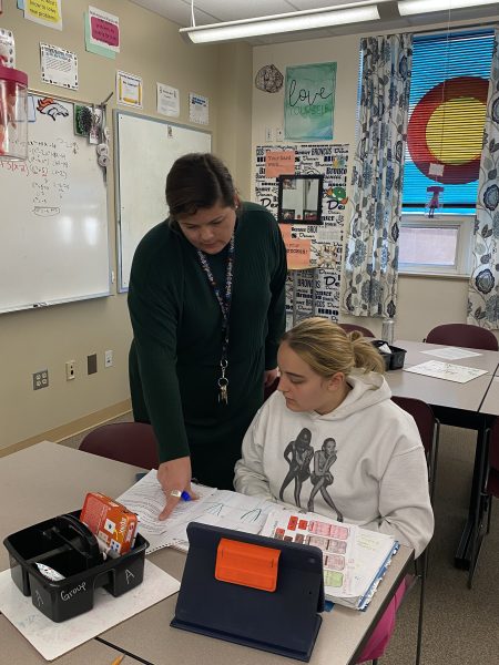 Jane Coppinger, math teacher at Silver Creek High School, teaches her student Magdeleine Des Moutis.