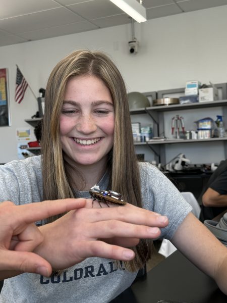 Fiona Henry a Silver Creek senior holding cyborg roach after completing the experiment.