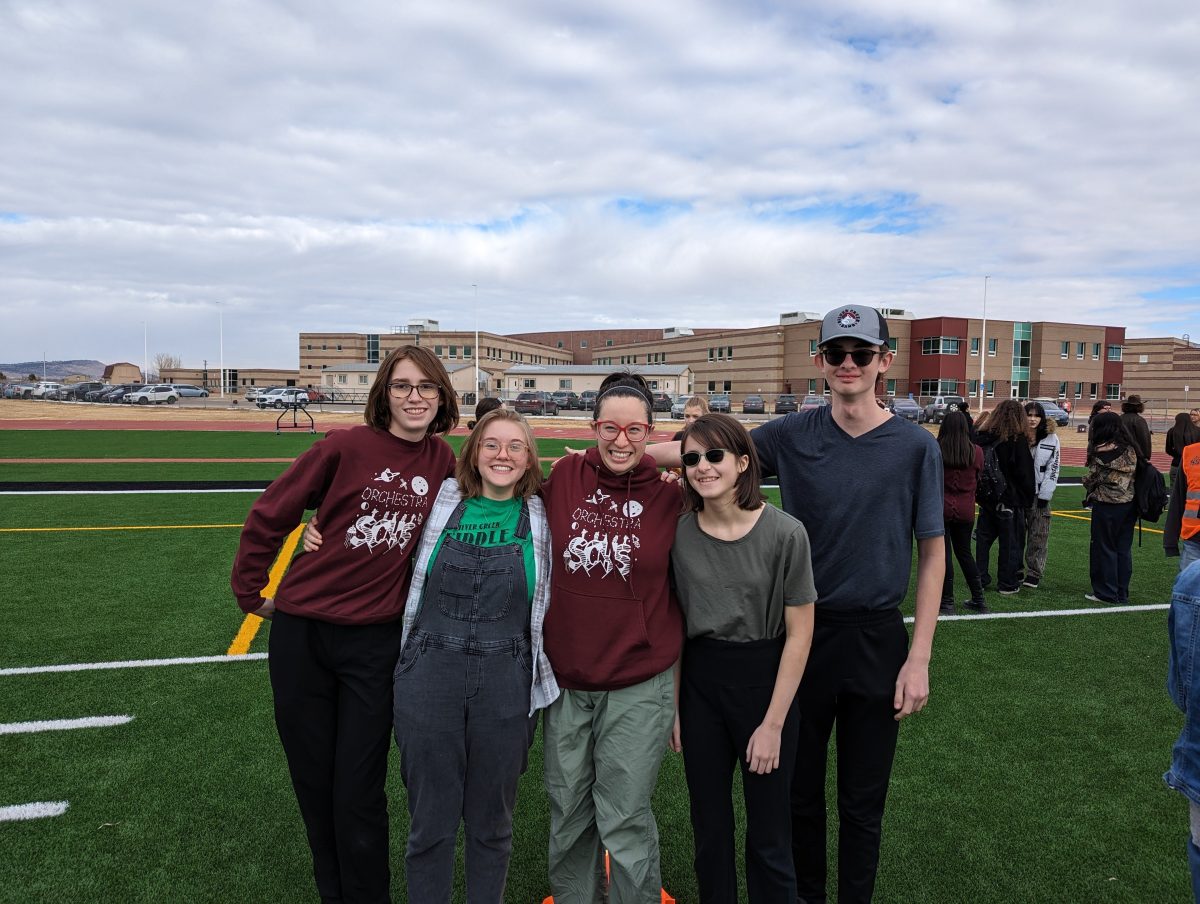 Orchestra members (left to right) Willow Cahill, Jorah Foote, Hannah Crill, and Nehemiah Crill, celebrate Courtney Dowling by dressing as her for the day. Photo courtesy of Joylynn Boardman. 