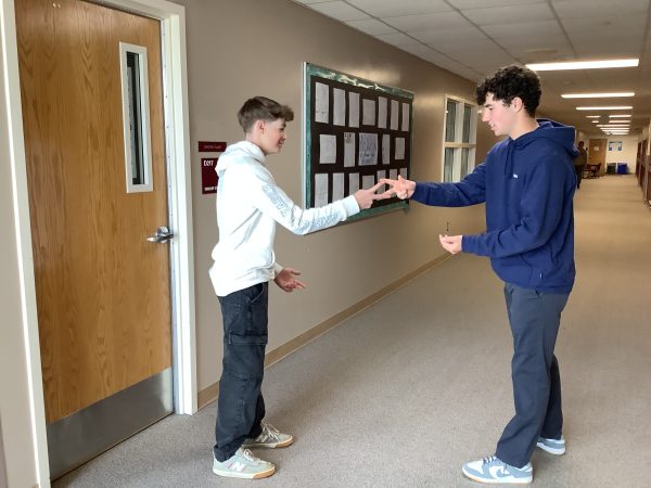 Ninth-grade students, Charlie Henry and Braeden Macchia, practicing rock-paper-scissors to prepare for the event.