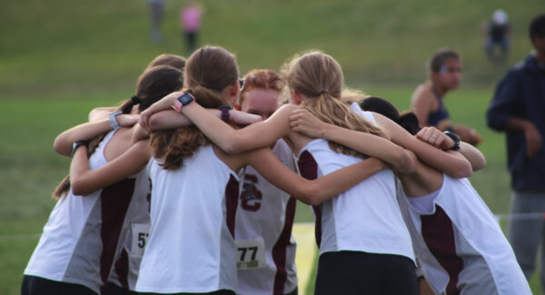 A Silver Creek Cross Country team huddle before heading to the start line on October 11th, 2024. Photo courtesy of Aaron Moe.