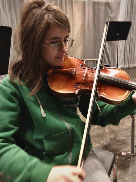 Hannah Crill, Silver Creek sophomore practices her violin in the auditorium for Symphonic Orchestra for her Concert on October 16, 2024.