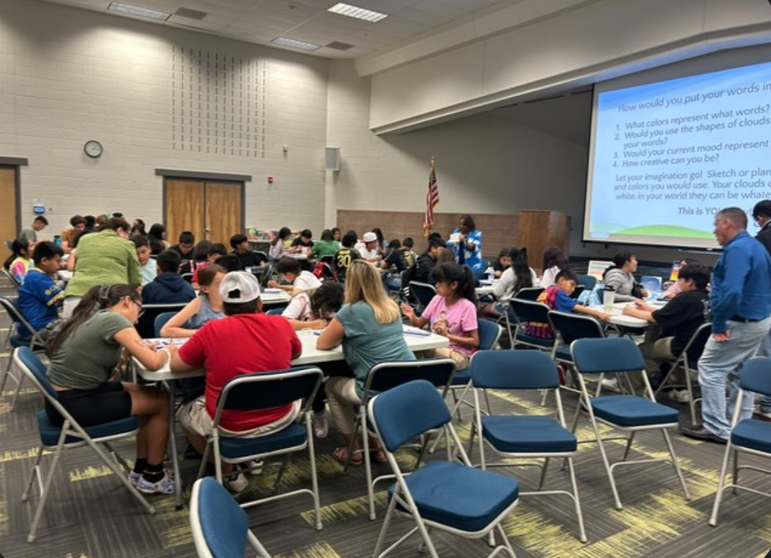 Silver Creek High School National Honors Society volunteers helping students at an elementary school learn about painting. 

Photo courtesy of Muskan Dhillon 