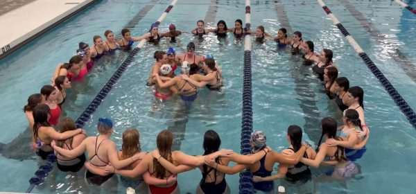 The Silver Creek Girls Swim Team huddled as they practice their team chant