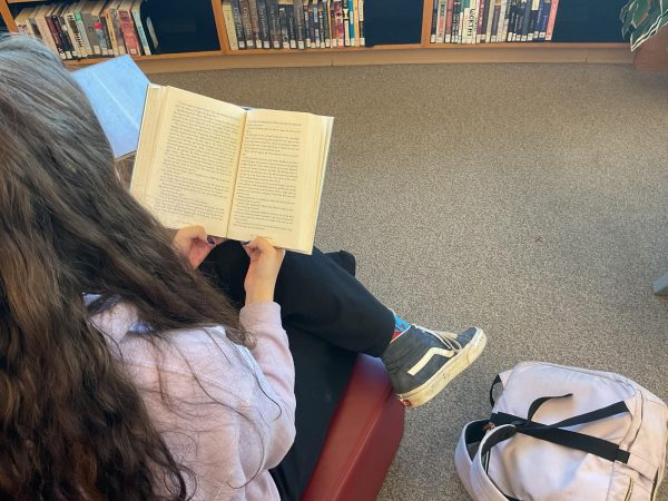 Ella Riley-McCoy reading a novel in Silver Creek High School’s library. 