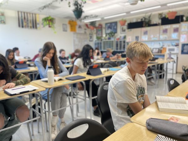 Grayson Schwirtz sits in Jason Lathrop’s Honors English 9 class during work time.