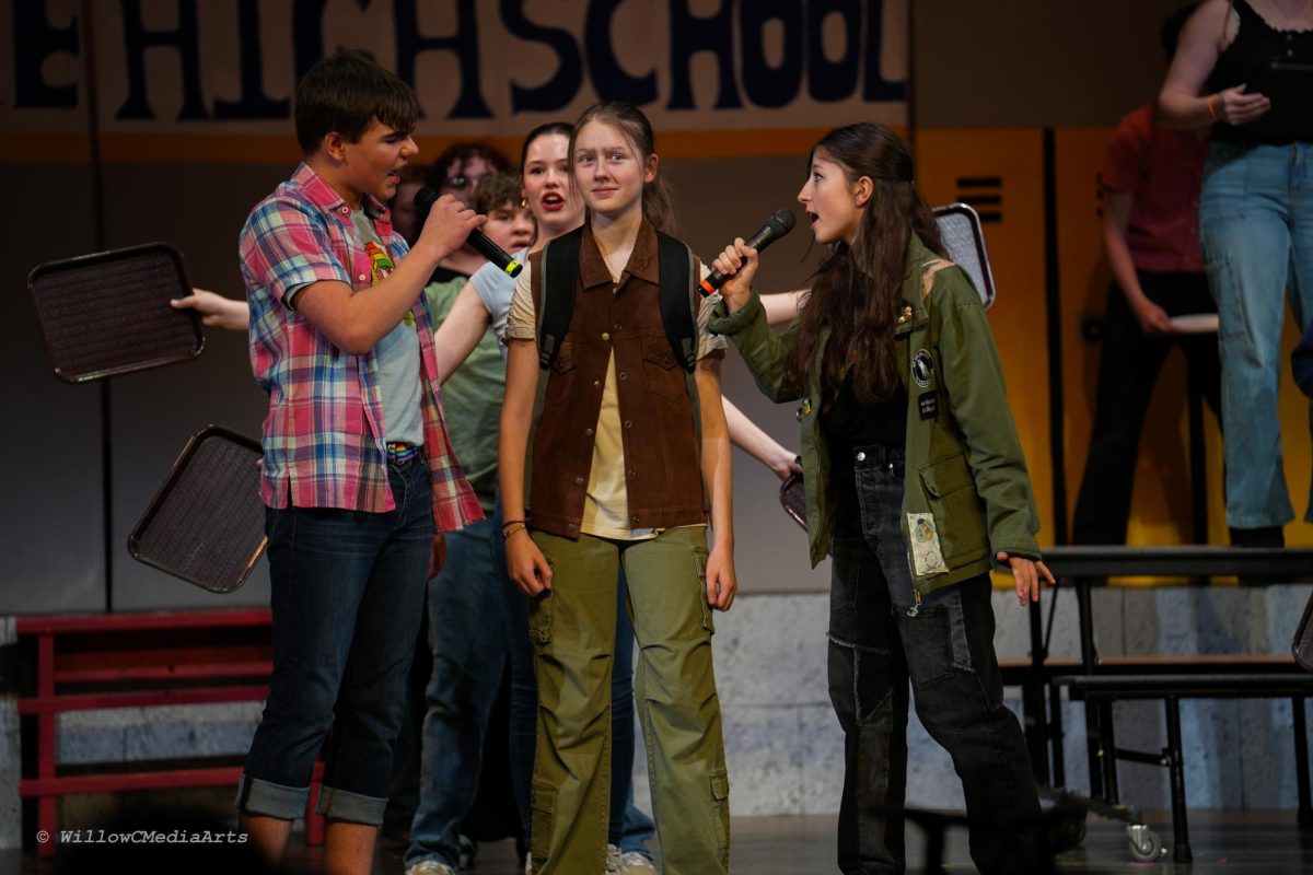 George Coupounas (as Damian Hubbard), Elsa Wirkkanen (as Cady Heron), and Coral Buchalter (as Janis Sarkasian), rehearsing for the debut night for the “Mean Girls The Musical.” 