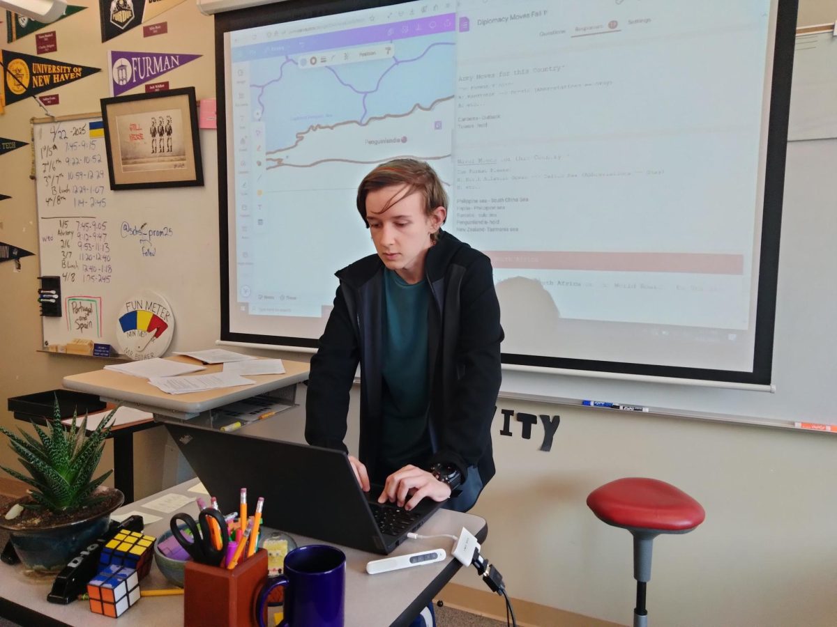 Landen Stinton reading out the moves for Diplomacy Club's World Board