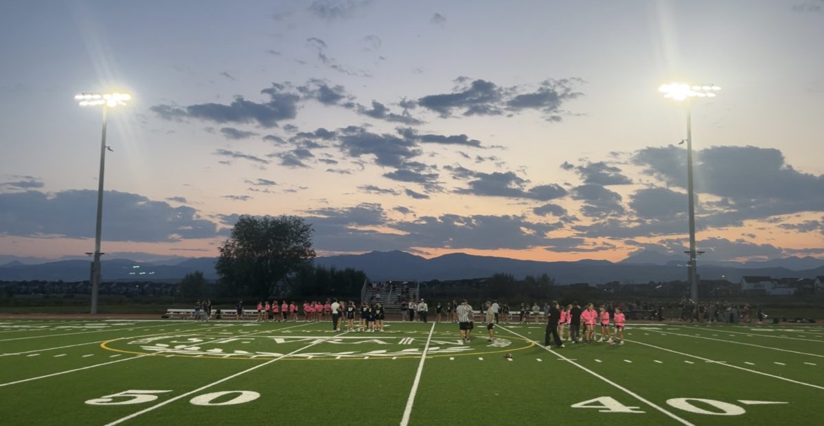 Players gather on Silver Creek’s football field during the Powder Puff game on September 3rd as the sun sets behind the mountains. 