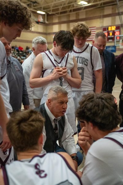 Bob Banning speaks to the Boys Basketball Raptors during their game against Niwot High School.