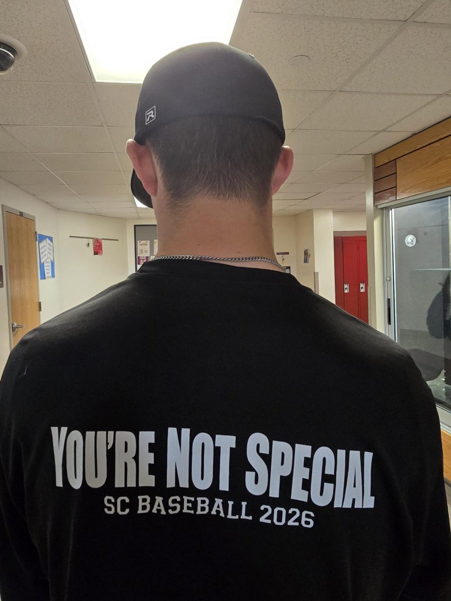 Audric Schatz wearing a baseball practice shirt on game day for team spirit.