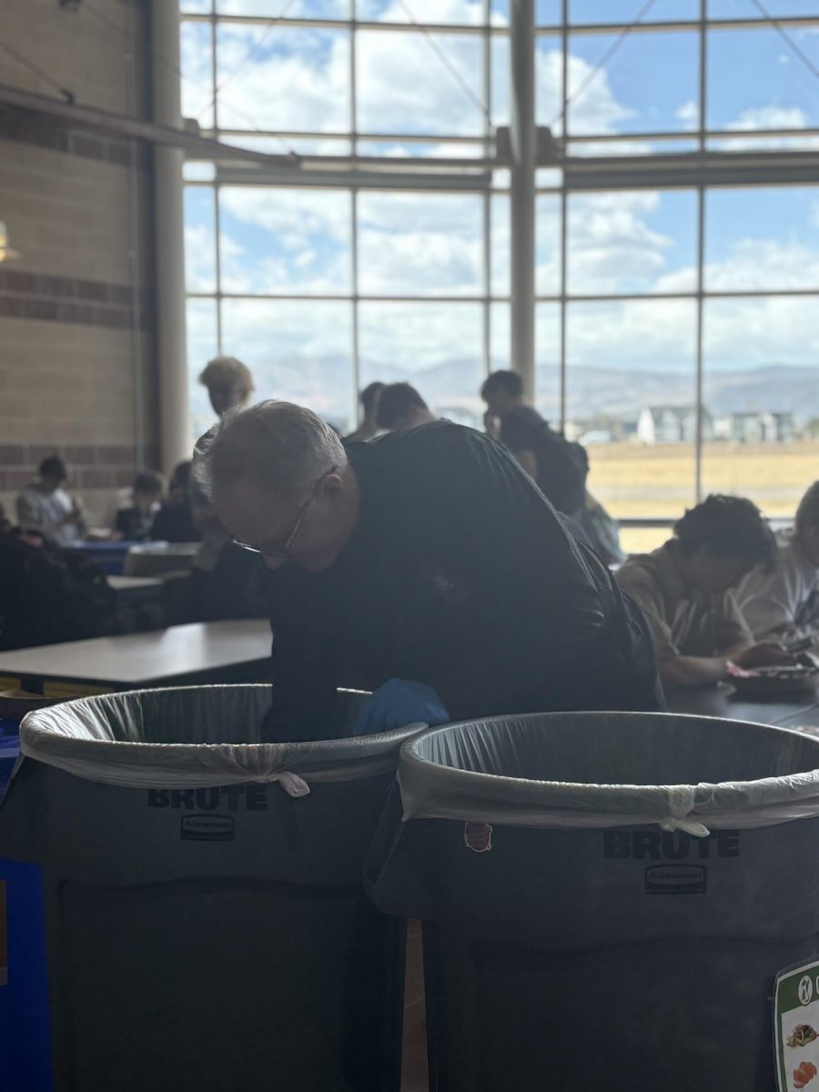 Eric Ottem, Assistant Principal at Silver Creek, sorts the trash, compost, and recyclables into the correct bins during lunch. This is one example of the many efforts staff and students around Silver Creek are making to limit the impact on the environment.